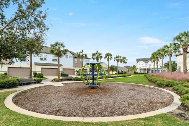 community playground featuring a lawn and a residential view