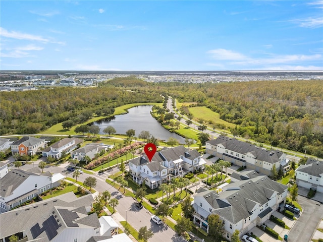 bird's eye view featuring a forest view, a water view, and a residential view