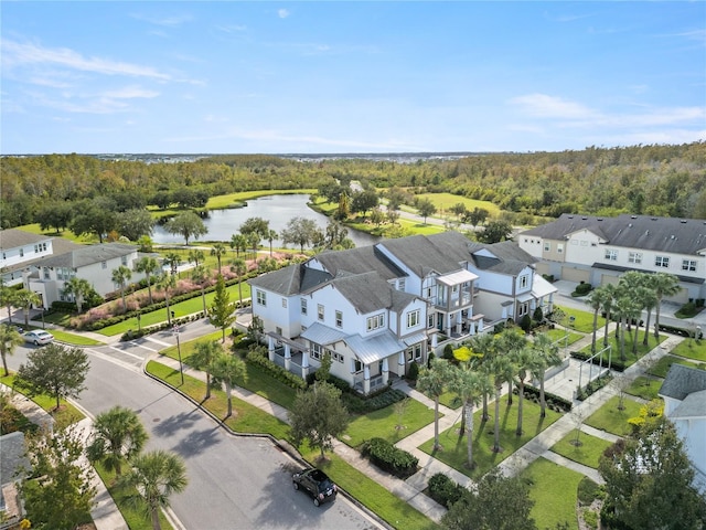 birds eye view of property featuring a residential view, a water view, and a view of trees