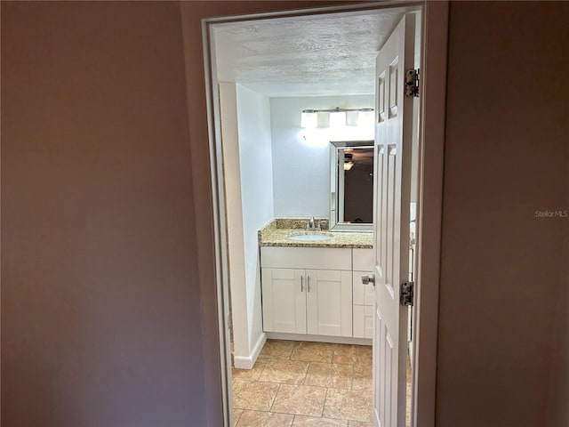 bathroom featuring vanity and a textured ceiling