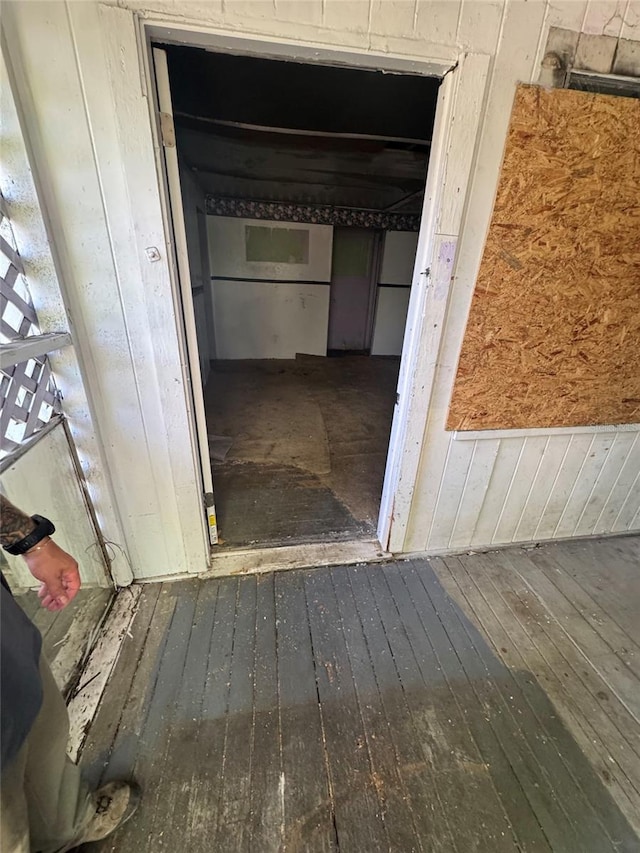 interior space with wooden walls and hardwood / wood-style flooring