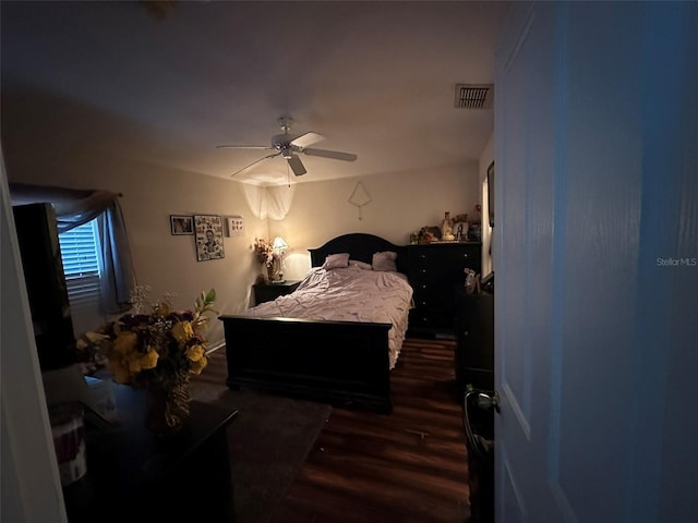 bedroom featuring ceiling fan and dark hardwood / wood-style floors