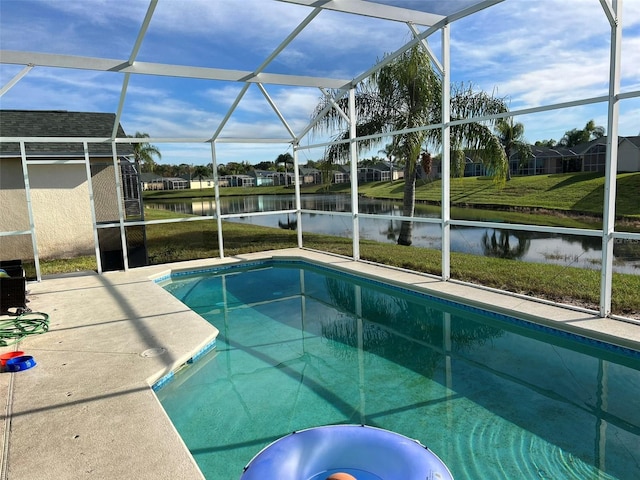 view of swimming pool featuring a lanai, a water view, a yard, and a patio area