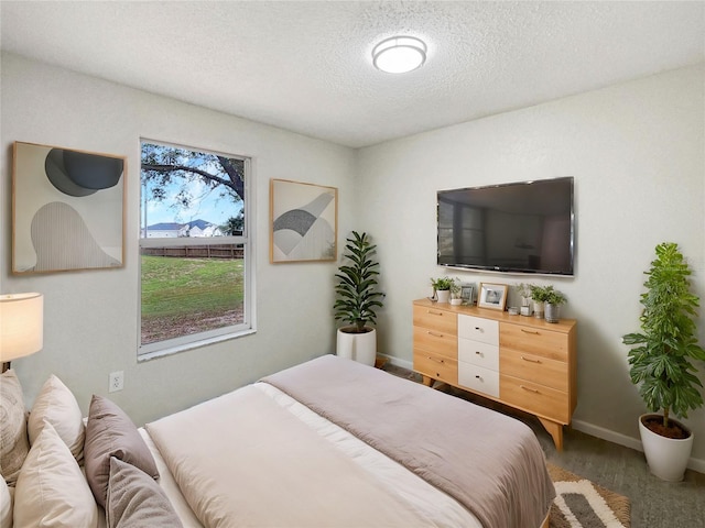 bedroom featuring a textured ceiling and dark hardwood / wood-style floors