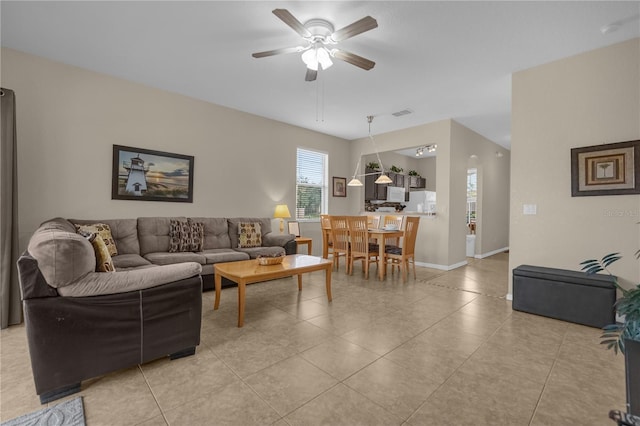 tiled living room with ceiling fan