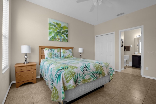 bedroom featuring ensuite bath, ceiling fan, a closet, and light tile patterned flooring