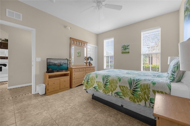 tiled bedroom featuring ceiling fan