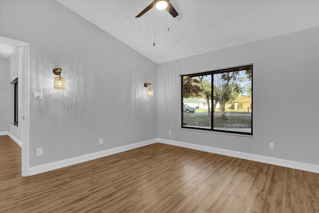 unfurnished room with ceiling fan, wood-type flooring, and vaulted ceiling