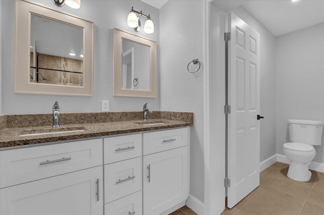 bathroom with tile patterned floors, vanity, and toilet