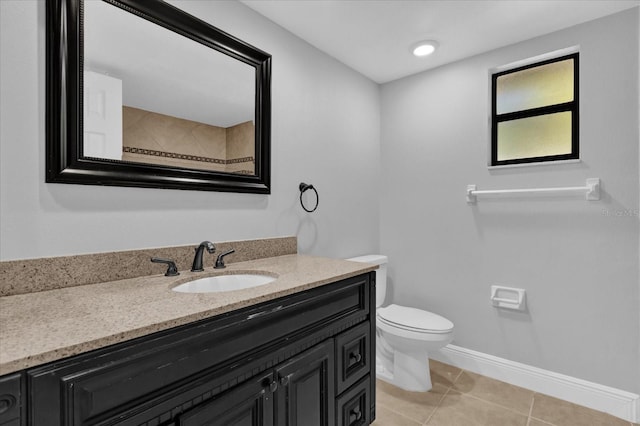 bathroom with tile patterned flooring, vanity, and toilet