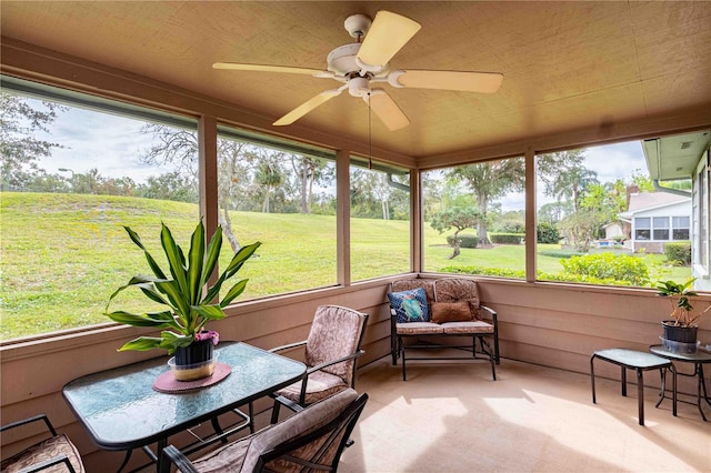 sunroom featuring ceiling fan