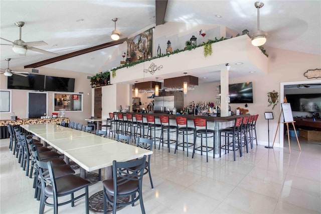 dining space featuring beam ceiling, ceiling fan, high vaulted ceiling, indoor bar, and light tile patterned floors