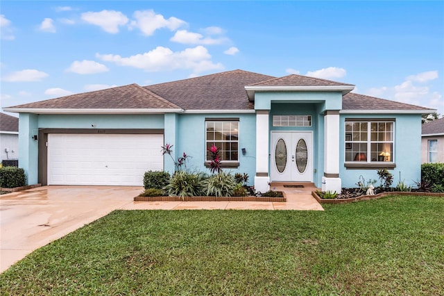 view of front of house with a garage and a front yard