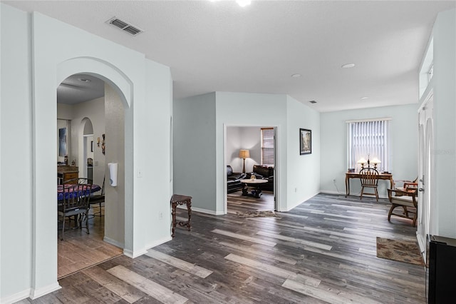 corridor featuring dark hardwood / wood-style flooring and a textured ceiling