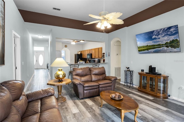 living room with light wood-type flooring and ceiling fan