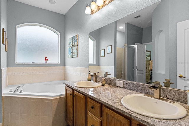 bathroom with independent shower and bath and vanity