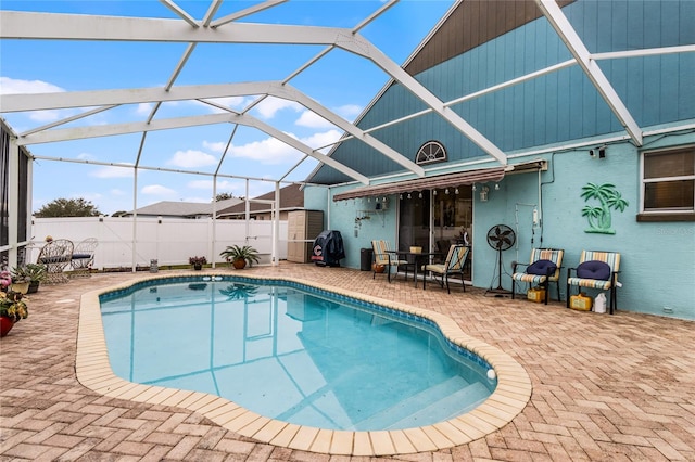 view of swimming pool with a lanai and a patio area