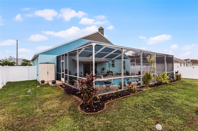 back of house featuring a fenced in pool, a storage shed, a patio, a lanai, and a yard