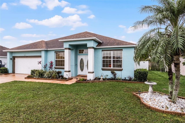 view of front of property with a garage and a front yard