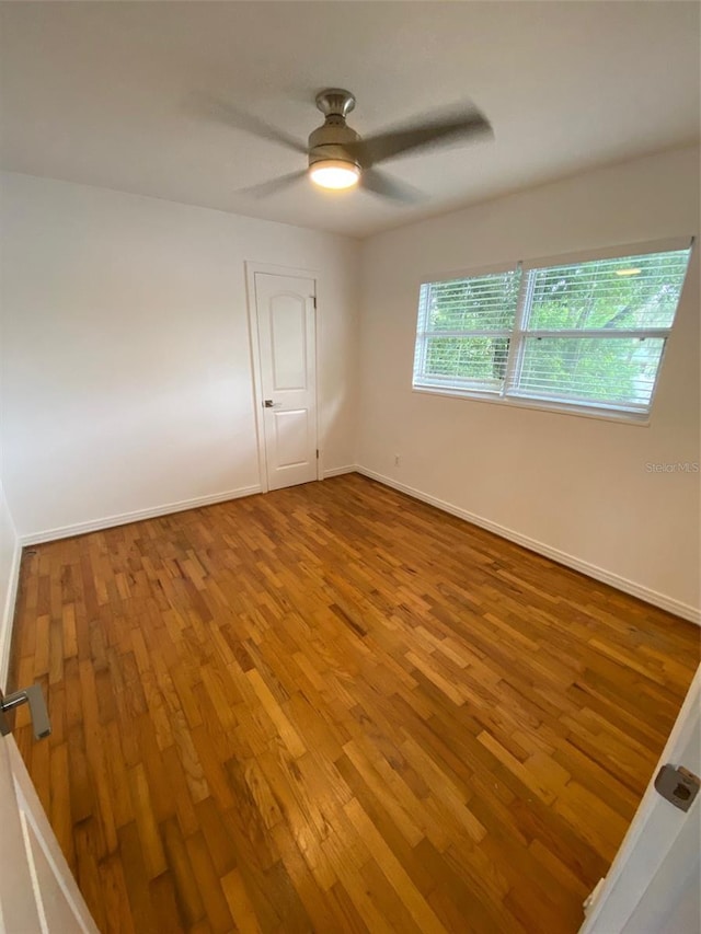 unfurnished room with hardwood / wood-style floors and ceiling fan