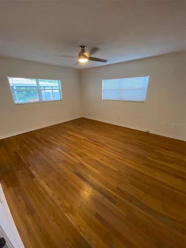 empty room featuring hardwood / wood-style floors and ceiling fan