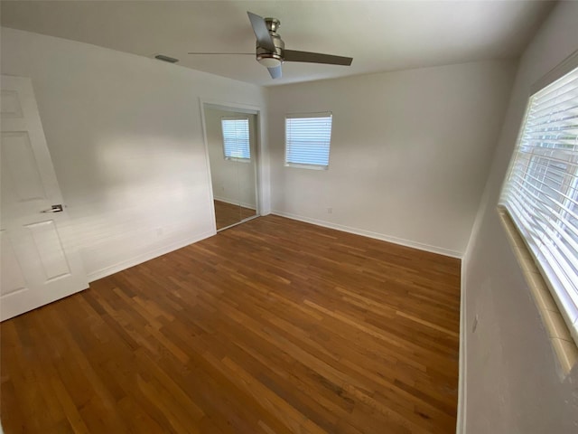 unfurnished bedroom with dark wood-type flooring and ceiling fan