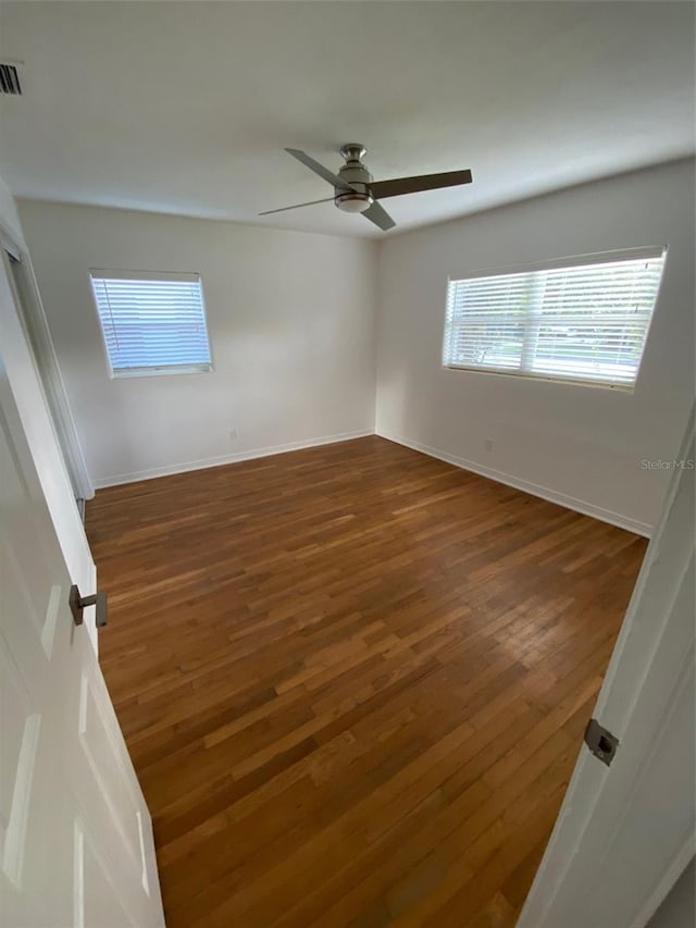 interior space with dark wood-type flooring and ceiling fan