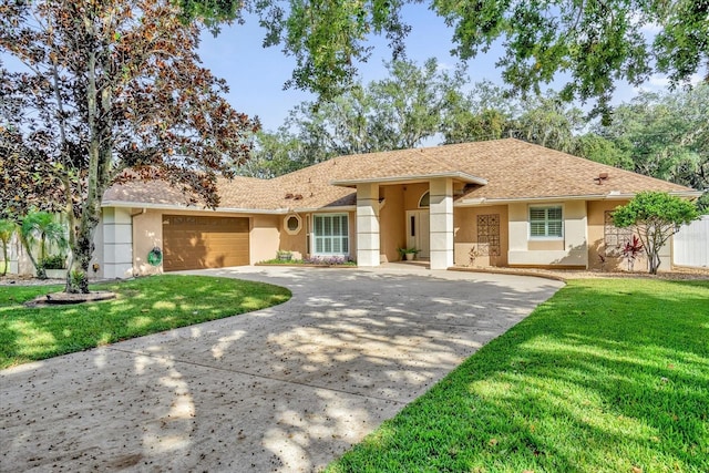 view of front of property with a garage and a front lawn