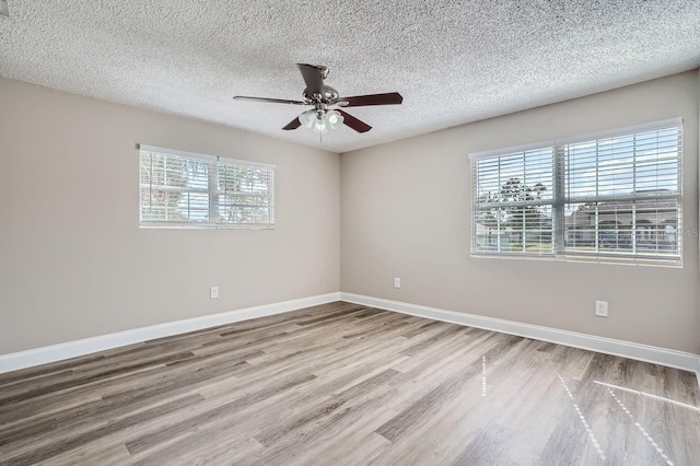 11335 Pickford St, Spring Hill, FL 34609 - spare room with wood finished floors, ceiling fan, a textured ceiling, and baseboards