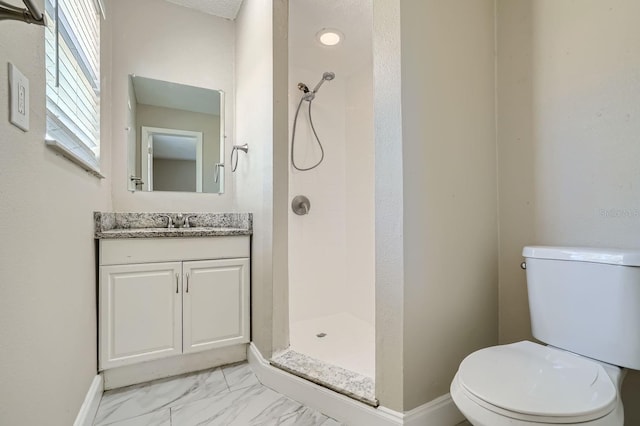 bathroom with walk in shower, vanity, and toilet