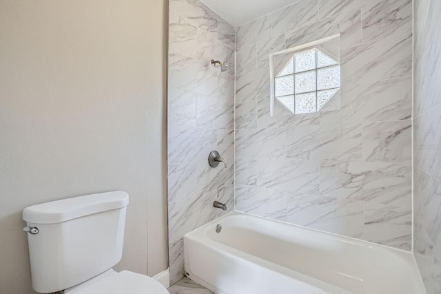 bathroom featuring toilet and tiled shower / bath combo