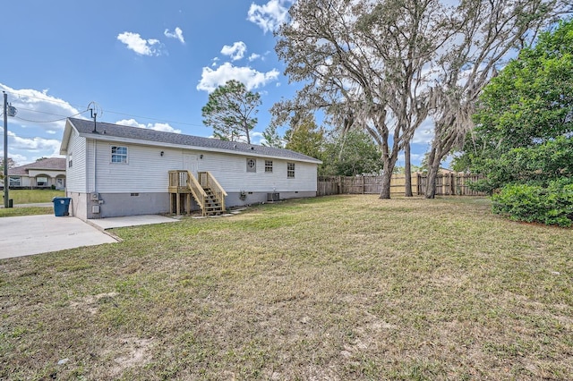 back of property featuring a lawn and a patio area