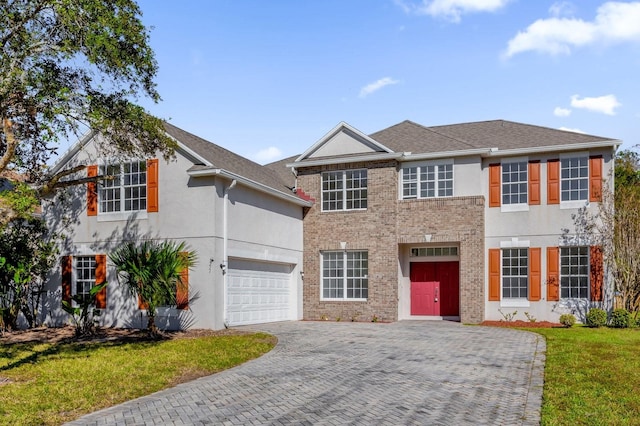 colonial home featuring a garage and a front yard