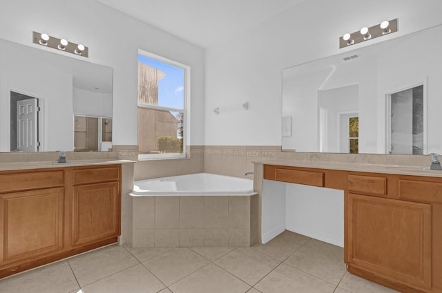 bathroom featuring tile patterned floors, vanity, and shower with separate bathtub