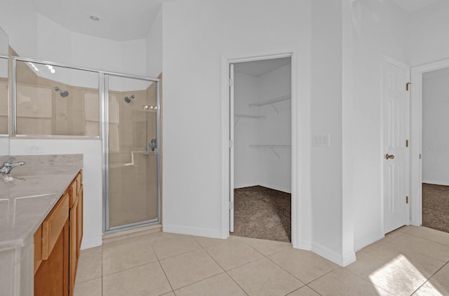 bathroom with tile patterned floors, vanity, and an enclosed shower