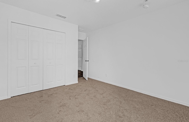 unfurnished bedroom featuring a closet and carpet