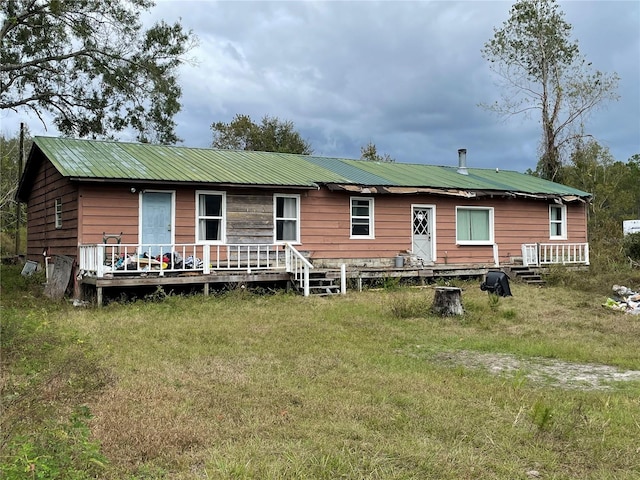 rear view of house with a lawn