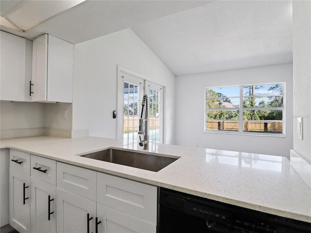 kitchen featuring white cabinets, a wealth of natural light, and vaulted ceiling