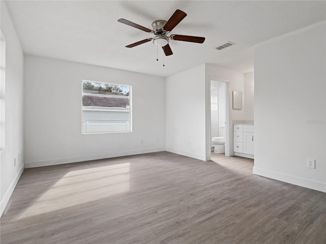 unfurnished room with light wood-type flooring and ceiling fan