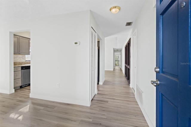 corridor with light wood-type flooring