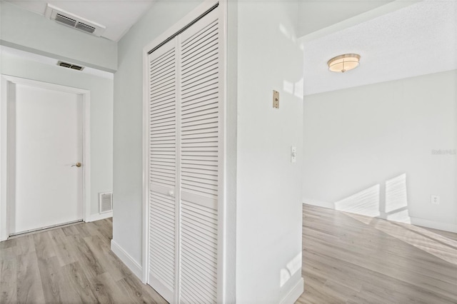 corridor with light hardwood / wood-style flooring