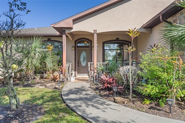 1562 Anorada Blvd, Kissimmee, FL 34744 - doorway to property with stucco siding and covered porch