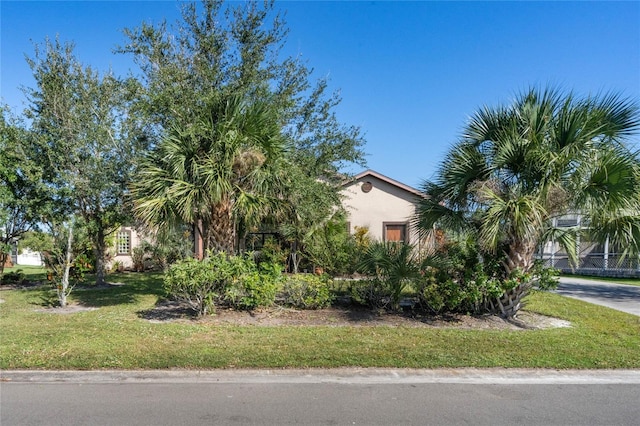 view of side of property with a yard