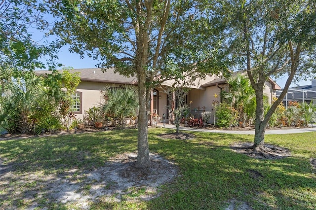 1562 Anorada Blvd, Kissimmee, FL 34744 - view of property hidden behind natural elements with stucco siding and a front yard
