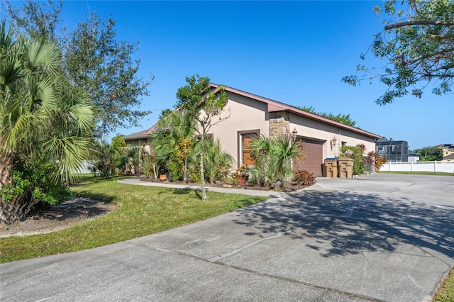 view of front of home with a garage and a front lawn