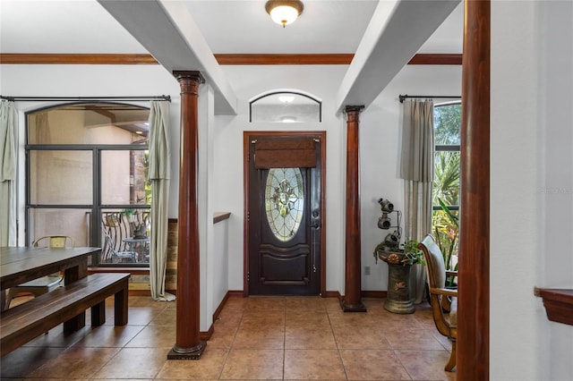 1562 Anorada Blvd, Kissimmee, FL 34744 - entrance foyer with decorative columns, crown molding, and tile patterned flooring