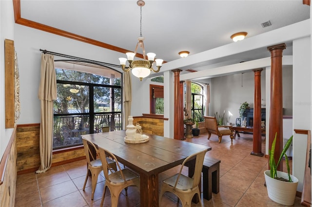 1562 Anorada Blvd, Kissimmee, FL 34744 - dining room with ornate columns, tile patterned flooring, a chandelier, and wainscoting