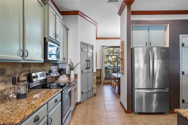 1562 Anorada Blvd, Kissimmee, FL 34744 - kitchen featuring stainless steel appliances, backsplash, stone counters, light tile patterned flooring, and crown molding