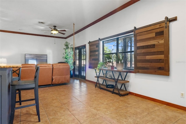 interior space featuring tile patterned flooring, a barn door, ceiling fan, and crown molding