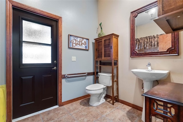 bathroom featuring toilet and tile patterned floors